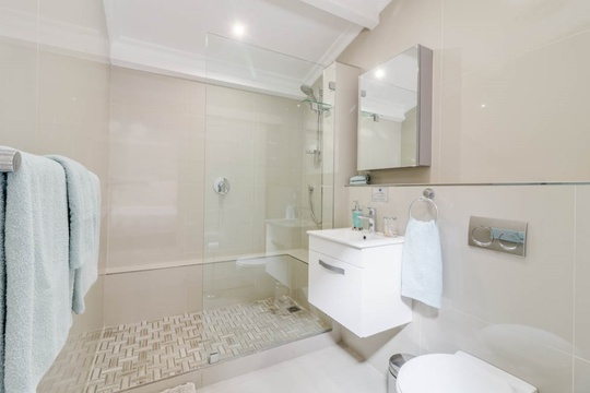 Master bedroom's en suite bathroom offers a shower.