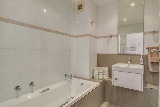 The second bathroom offers a bath with shower facilities.